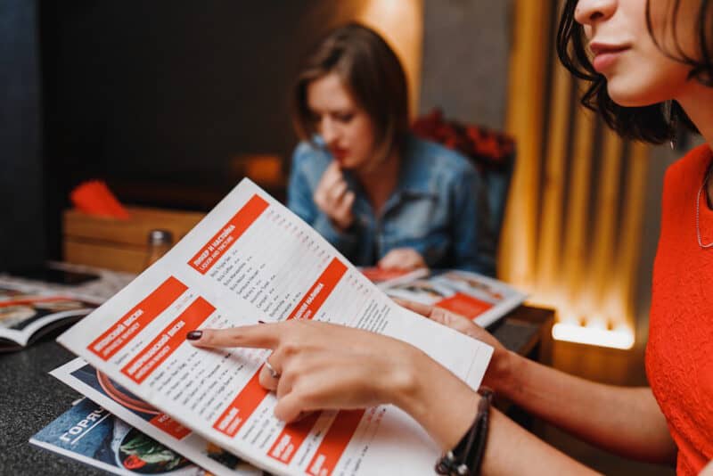 customers looking at restaurant menu