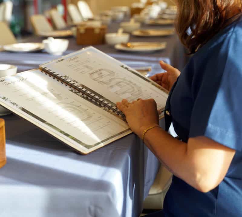 woman looking at restaurant menu