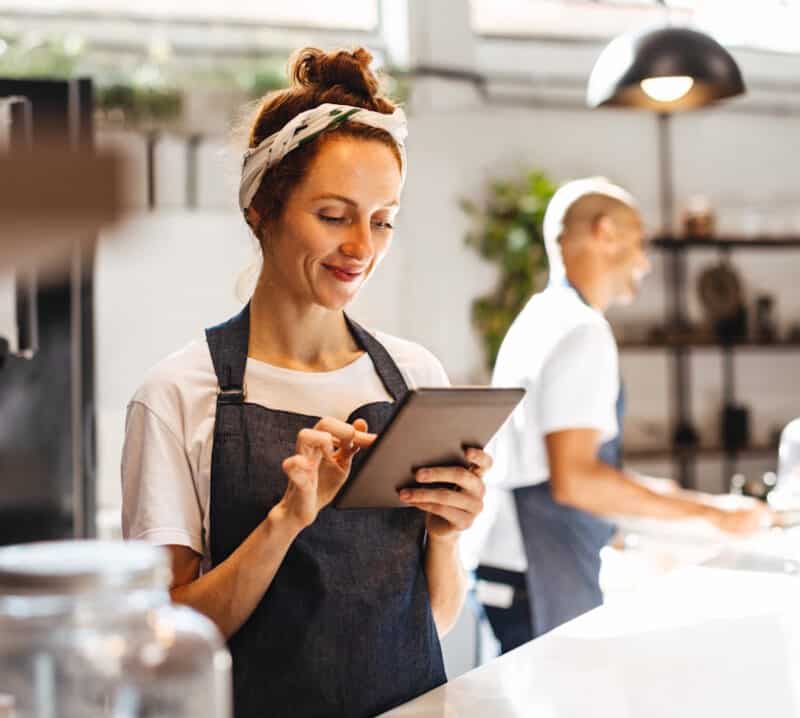 manager reviewing menu on tablet