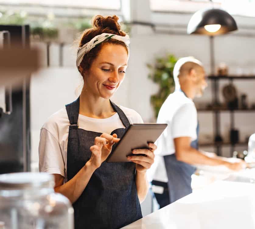 manager reviewing menu on tablet