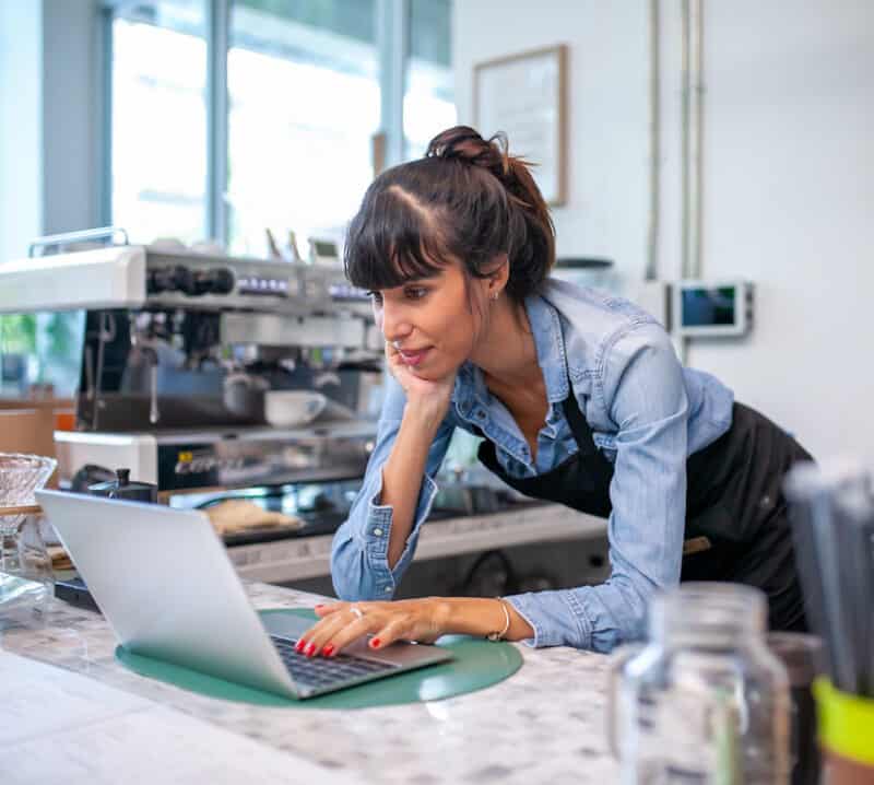 coffee shop owner on laptop