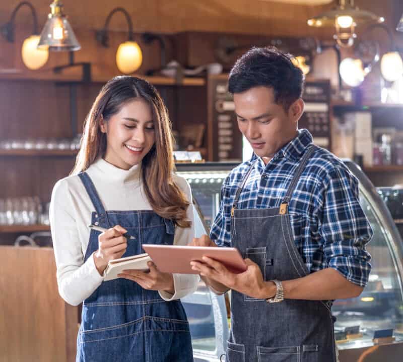 restaurant owners looking at ipad
