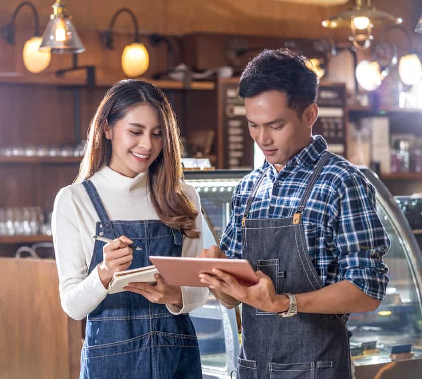 restaurant owners looking at ipad